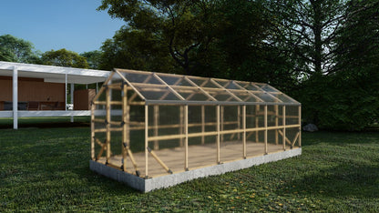 Wooden greenhouse on a grassy area with trees in the background