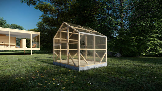 Wooden greenhouse on a grassy area with trees in the background